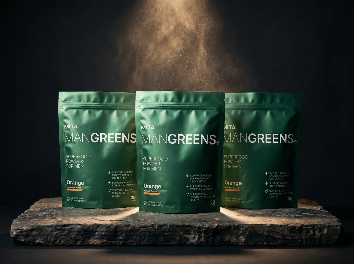 Three bags of Man Greens on a stone slab